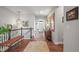 Welcoming foyer with hardwood floors, staircase, bench, and decorative mirrors creating a warm ambiance at 6705 S Catawba Way, Aurora, CO 80016