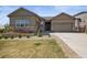 Beautiful single-Gathering home with manicured front yard, stone accents, and an attached two-car garage at 6705 S Catawba Way, Aurora, CO 80016