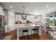 Bright kitchen featuring a large island with seating, pendant lighting, and modern stainless-steel appliances at 6705 S Catawba Way, Aurora, CO 80016