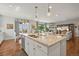 Bright, open kitchen featuring a large island with granite countertops and modern pendant lighting at 6705 S Catawba Way, Aurora, CO 80016