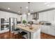 Modern kitchen boasting stainless steel appliances, granite countertops, and a functional island with bar stools at 6705 S Catawba Way, Aurora, CO 80016
