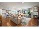 Spacious open-concept living room with hardwood floors, fireplace, and an adjacent modern kitchen at 6705 S Catawba Way, Aurora, CO 80016