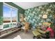 Bright home office with a large window, floral wallpaper, and comfortable seating area at 6705 S Catawba Way, Aurora, CO 80016