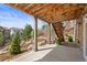 Covered patio with views of landscaped backyard and outdoor staircase at 6705 S Catawba Way, Aurora, CO 80016