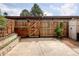 Private backyard featuring a tall wooden fence, brick pavers, and concrete patio at 13017 W 20Th Ave, Golden, CO 80401