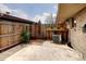 Private backyard featuring a tall wooden fence, brick pavers, and concrete patio at 13017 W 20Th Ave, Golden, CO 80401