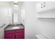 This bathroom features a sink with granite countertop, built in wall shelving and toilet at 13017 W 20Th Ave, Golden, CO 80401