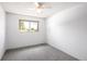 Cozy bedroom features soft carpeting, a ceiling fan, and natural light from the window at 13017 W 20Th Ave, Golden, CO 80401