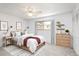 This bedroom has a ceiling fan, window, closet and is decorated with artwork and plants at 13017 W 20Th Ave, Golden, CO 80401