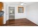 A dining room with wood floors and a pass-through to the living area at 13017 W 20Th Ave, Golden, CO 80401