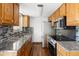 This kitchen has stone countertops, stainless steel appliances and grey backsplash at 13017 W 20Th Ave, Golden, CO 80401