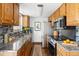 This kitchen has stone countertops, stainless steel appliances and grey backsplash at 13017 W 20Th Ave, Golden, CO 80401