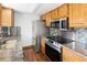 This kitchen features updated stainless appliances and granite countertops at 13017 W 20Th Ave, Golden, CO 80401