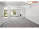 Bright living room featuring neutral carpet, fireplace, and a ceiling fan at 13017 W 20Th Ave, Golden, CO 80401