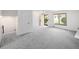 Spacious living room features neutral carpet, natural light, and a door to the outside at 13017 W 20Th Ave, Golden, CO 80401