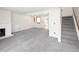 Bright living room features neutral carpet, natural light, fireplace and stairs at 13017 W 20Th Ave, Golden, CO 80401