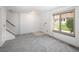 Spacious living room features neutral carpet, natural light, and stairs to the upper level at 13017 W 20Th Ave, Golden, CO 80401