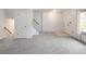 Expansive living room features neutral carpet, natural light, and stairs to the upper level at 13017 W 20Th Ave, Golden, CO 80401