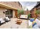 Cozy patio with comfortable seating, wood fencing, and sliding door access to the house at 13017 W 20Th Ave, Golden, CO 80401