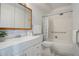 Bright bathroom featuring a vanity, mirror, toilet, and a shower/tub combination with white tiled walls at 3164 S Wheeling Way # 101, Aurora, CO 80014