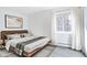 Serene bedroom with a minimalist design, a platform bed, hardwood floors, and bright window with white drapes at 3164 S Wheeling Way # 101, Aurora, CO 80014