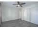 Bedroom with ceiling fan, neutral walls, laminate floors, and large closet with sliding doors at 3164 S Wheeling Way # 101, Aurora, CO 80014