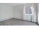Spacious bedroom featuring neutral walls, laminate floors and a window covered by long curtains at 3164 S Wheeling Way # 101, Aurora, CO 80014