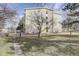 Exterior of building with a tree, sidewalks, grass, and minimal landscaping at 3164 S Wheeling Way # 101, Aurora, CO 80014