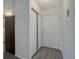 Hallway with laminate flooring, storage closet, and easy access to kitchen, living area, and front door at 3164 S Wheeling Way # 101, Aurora, CO 80014