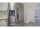 Stainless steel french door refrigerator with water dispenser in kitchen with white cabinets and gray vinyl floor at 3164 S Wheeling Way # 101, Aurora, CO 80014