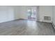 Living room with sliding glass door, air conditioner, and gray vinyl floors at 3164 S Wheeling Way # 101, Aurora, CO 80014