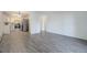 Open concept living room with kitchen, gray vinyl floors, and white walls at 3164 S Wheeling Way # 101, Aurora, CO 80014