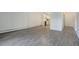 Open concept living room with kitchen, gray vinyl floors, and white walls at 3164 S Wheeling Way # 101, Aurora, CO 80014