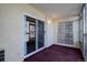 Enclosed sunroom/patio featuring sliding glass doors, a small light fixture, and carpeted floors at 3164 S Wheeling Way # 101, Aurora, CO 80014