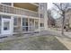 Enclosed sunroom/patio with glass windows, brick accents, and a sliding glass door to a patio at 3164 S Wheeling Way # 101, Aurora, CO 80014
