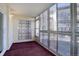 Enclosed sunroom/patio featuring brick accents, large windows, carpeted floor and white walls at 3164 S Wheeling Way # 101, Aurora, CO 80014