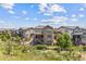 Expansive aerial view showcasing the home's backyard, including a covered patio, and a well-manicured yard with a putting green at 10401 Maplebrook Way, Highlands Ranch, CO 80126