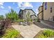 The backyard features a stone patio with seating, mature landscaping, and a cozy outdoor space at 10401 Maplebrook Way, Highlands Ranch, CO 80126