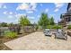 A tranquil backyard features a stone patio, lush greenery, and a serene outdoor seating area at 10401 Maplebrook Way, Highlands Ranch, CO 80126