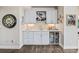 A stylish wet bar features a wine fridge, storage, and elegant countertops for seamless entertaining at 10401 Maplebrook Way, Highlands Ranch, CO 80126