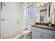 Bathroom featuring a glass-enclosed shower, neutral tile and sleek fixtures at 10401 Maplebrook Way, Highlands Ranch, CO 80126