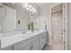 Bathroom featuring a double sink vanity with a large mirror and lighting, plus a separate shower area at 10401 Maplebrook Way, Highlands Ranch, CO 80126