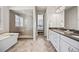 Bathroom showcasing a glass shower with bench and soaking tub, complemented by a dual sink vanity at 10401 Maplebrook Way, Highlands Ranch, CO 80126
