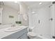 A modern bathroom features a glass-enclosed shower and a sleek vanity with a minimalist design at 10401 Maplebrook Way, Highlands Ranch, CO 80126