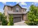 Exterior shot featuring a two-story home with gray siding and a two-car garage at 10401 Maplebrook Way, Highlands Ranch, CO 80126