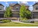Charming two-story home featuring a bench in the front yard with lush landscaping and an attached two-car garage at 10401 Maplebrook Way, Highlands Ranch, CO 80126