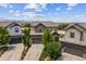 Exterior shot of a two-story home with lush landscaping and a driveway at 10401 Maplebrook Way, Highlands Ranch, CO 80126