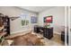 Home office with executive desk, sports decor, Texas flag, and decorative cowhide rug at 10401 Maplebrook Way, Highlands Ranch, CO 80126