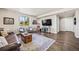 A spacious living room features a large TV, stylish seating, and a decorative rug at 10401 Maplebrook Way, Highlands Ranch, CO 80126