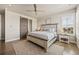 Main bedroom with hardwood floors, ceiling fan, large windows and sliding barn door at 10401 Maplebrook Way, Highlands Ranch, CO 80126